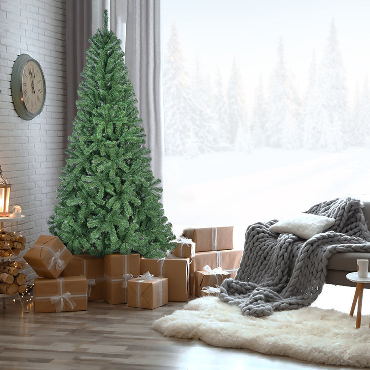 a christmas tree with presents in front of a window