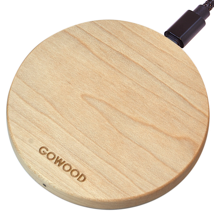 a wooden circular object with a black cord