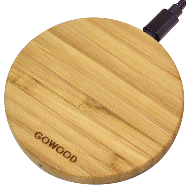 a circular wooden surface with a black cord
