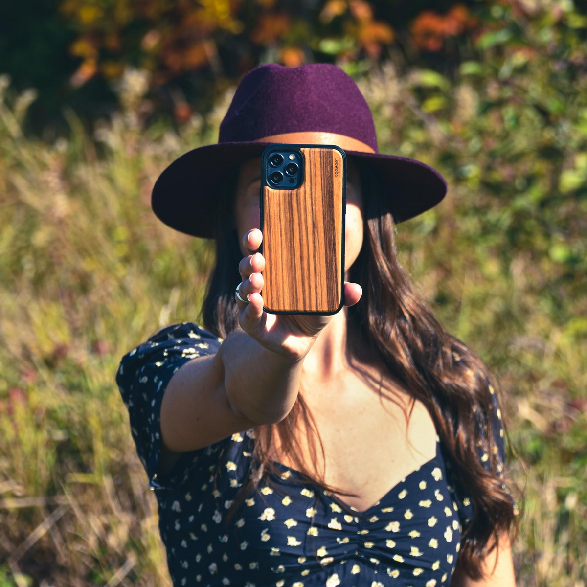 a woman holding a phone in front of her face