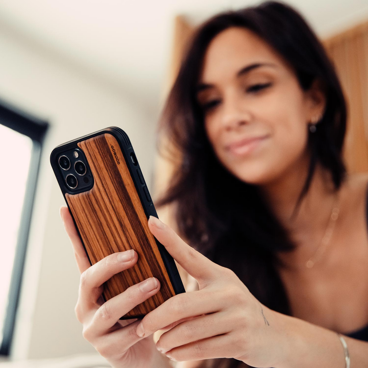 a woman holding a phone