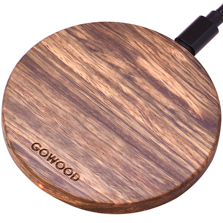 a circular wooden object with a black cord