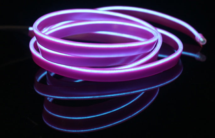 a purple light strip on a black surface