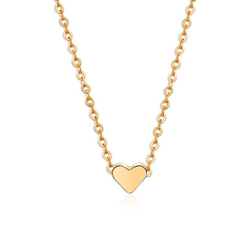 a gold heart necklace with a chain
