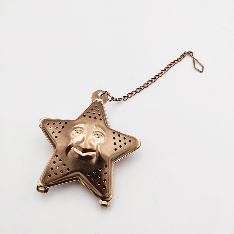 a star shaped tea strainer with a face on it