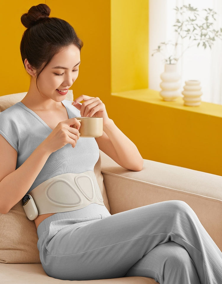 a woman sitting on a couch holding a cup