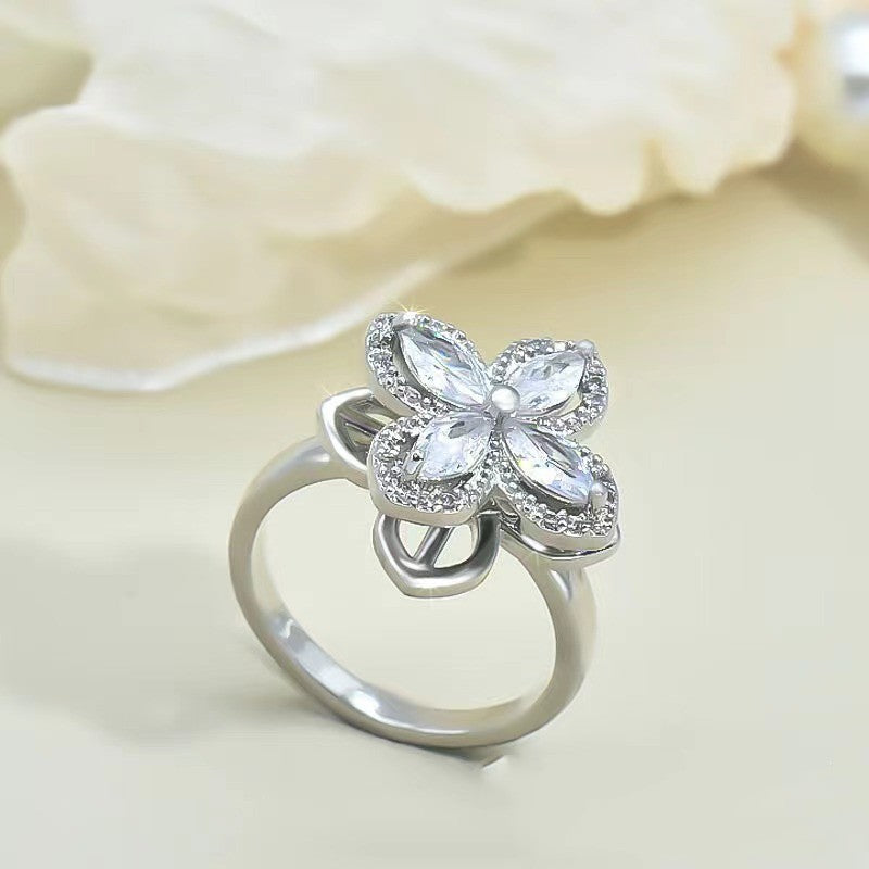 a silver ring with a flower shaped stone