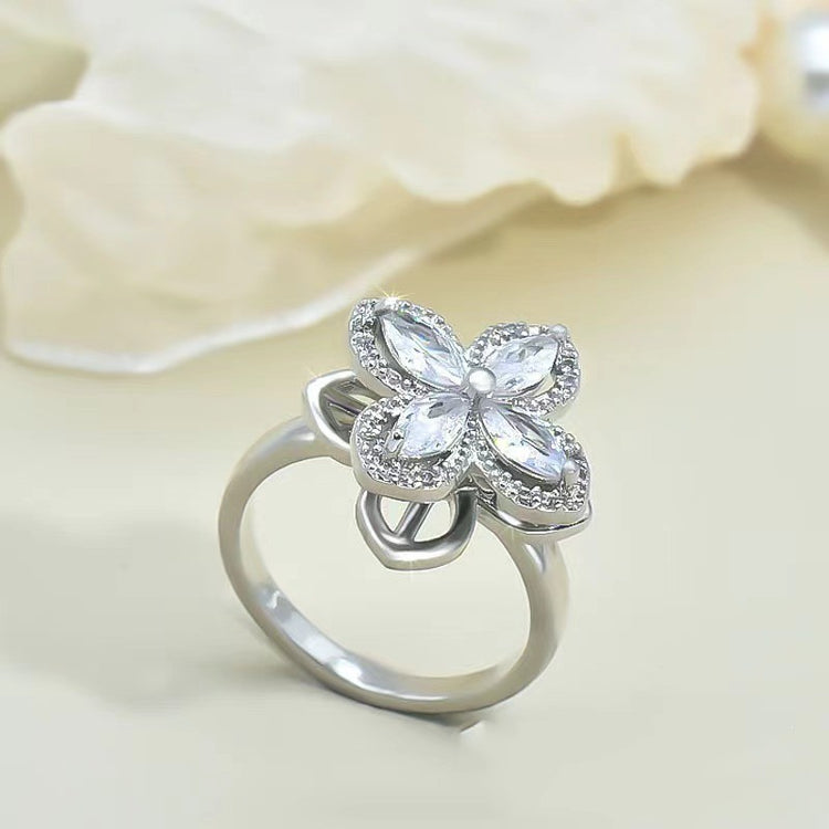 a silver ring with a flower shaped stone
