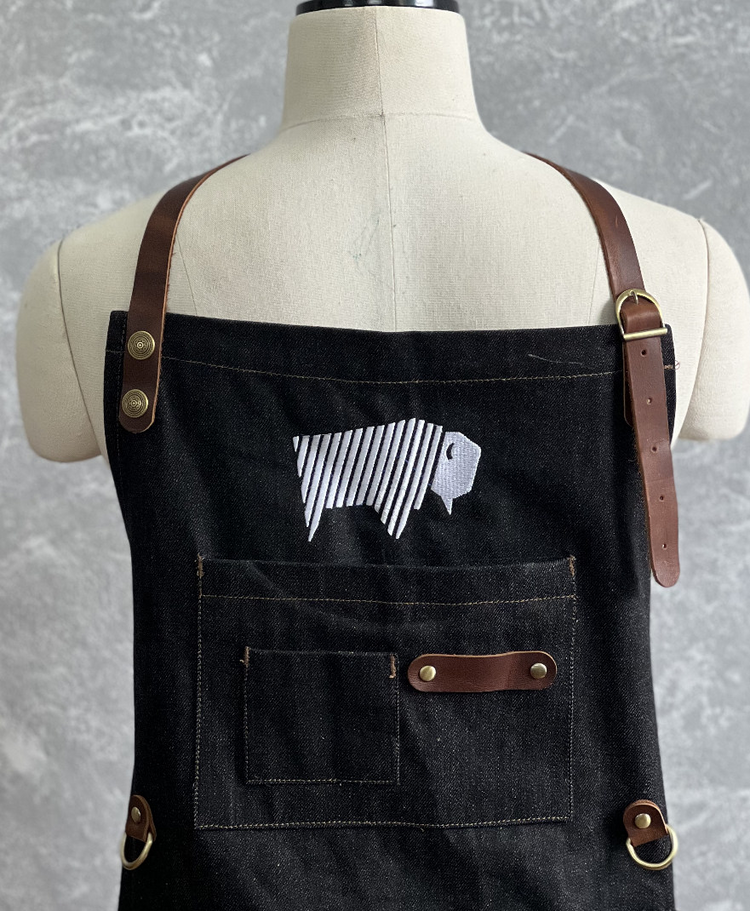 a black apron with a white and black design on it