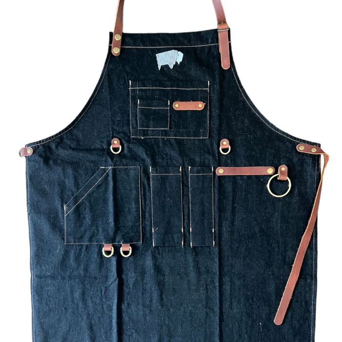 a black apron with brown straps