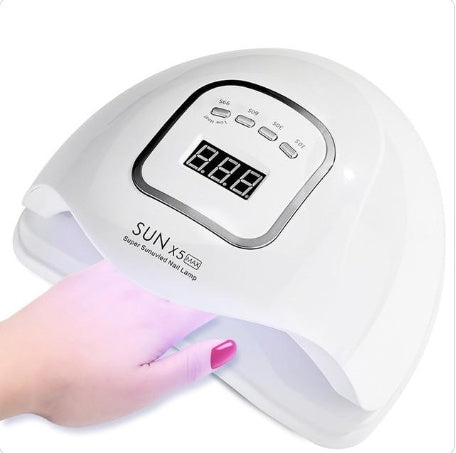 a hand holding a uv lamp