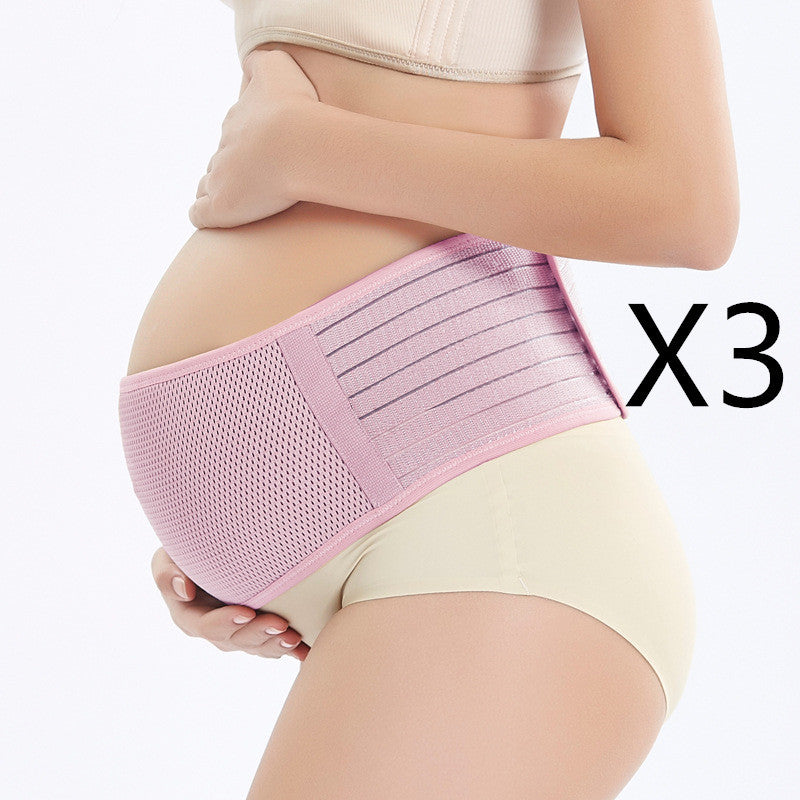 a pregnant woman wearing a pink belly band