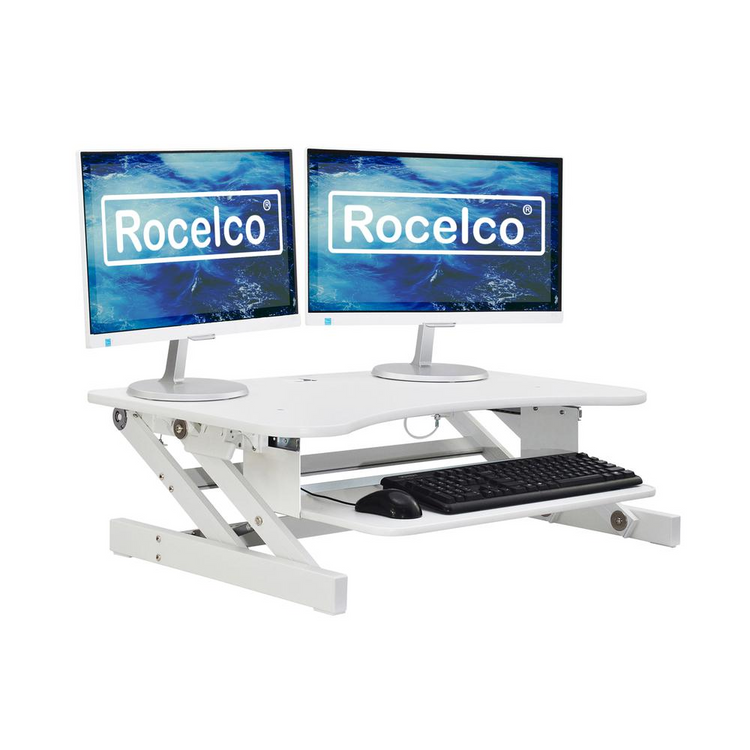 a white desk with two monitors and a keyboard