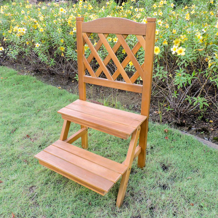 a wooden chair in a grassy area