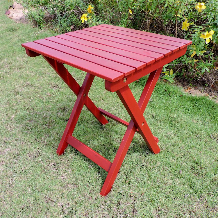 a red table in a grass field