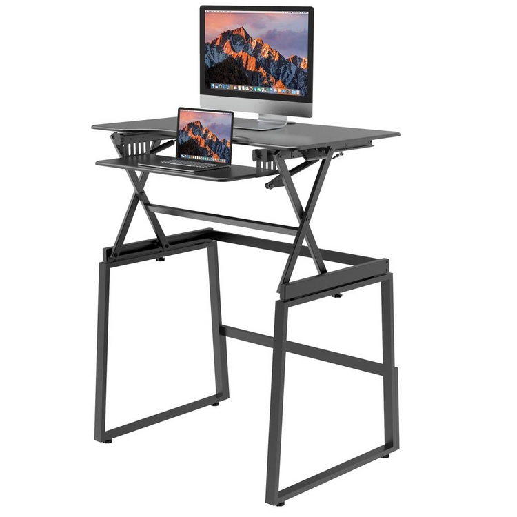 a black desk with a computer and a laptop