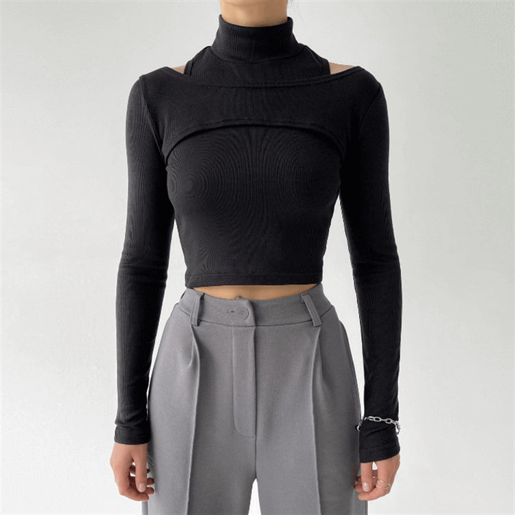 a woman wearing a black turtleneck and grey pants