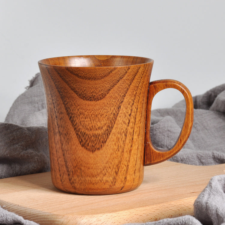 a wooden mug on a cutting board