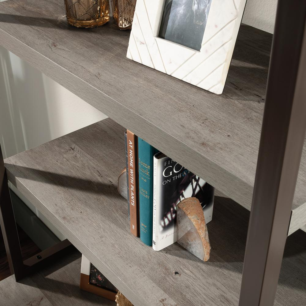 a shelf with books and a picture frame
