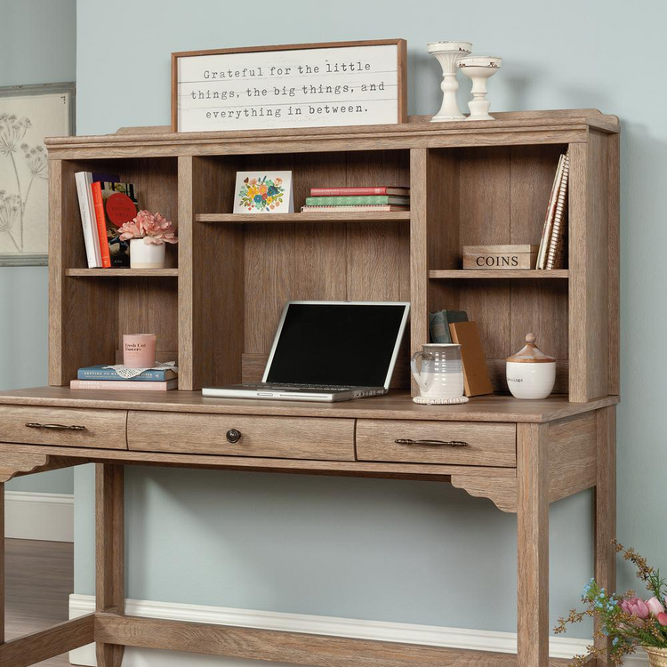 a desk with a laptop and shelves