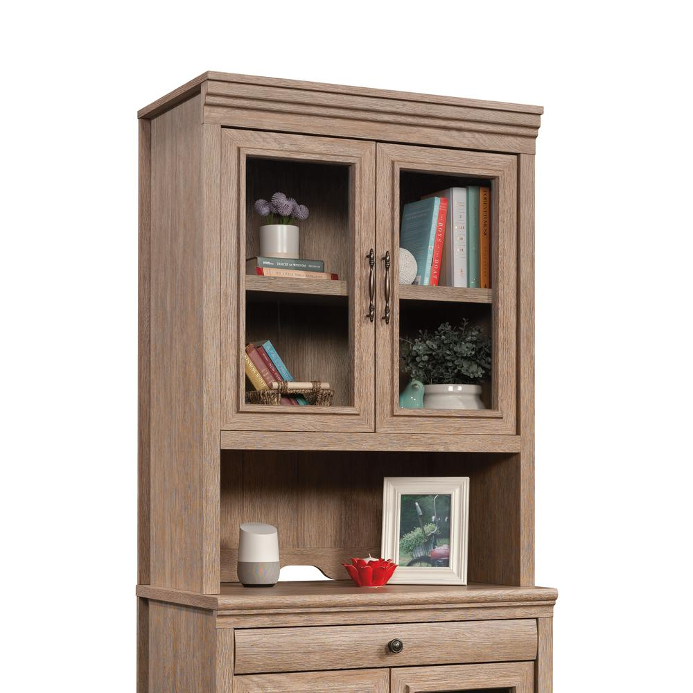 a wooden cabinet with books and pictures on it