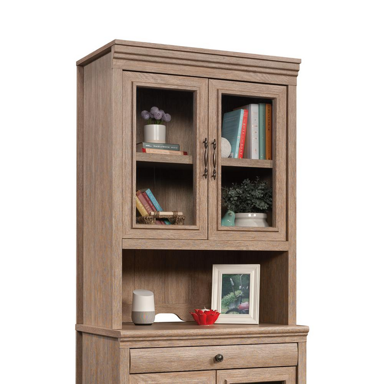a wooden cabinet with books and pictures on it