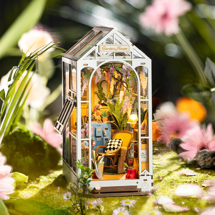 a miniature house with a glass and a table and chairs