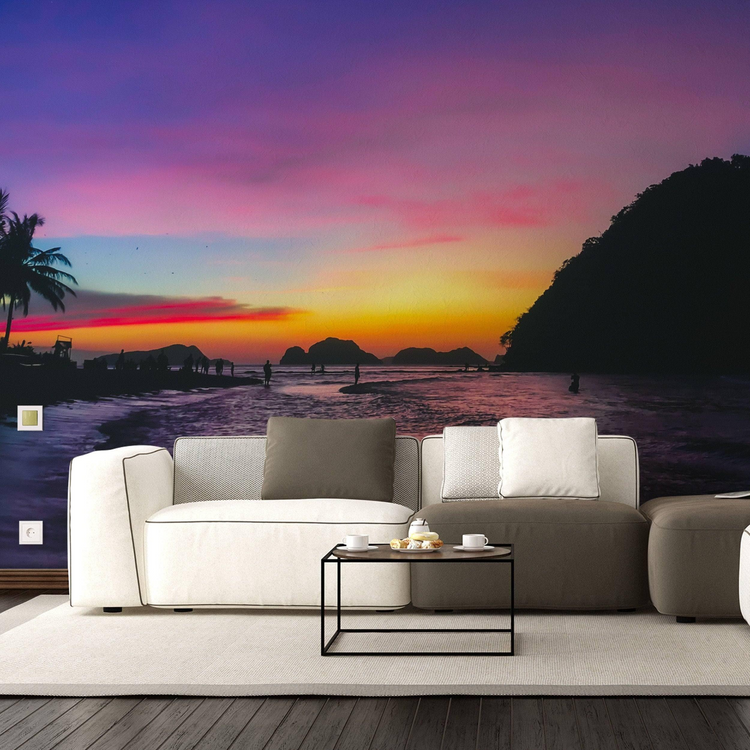 a couch in a room with a sunset on the wall