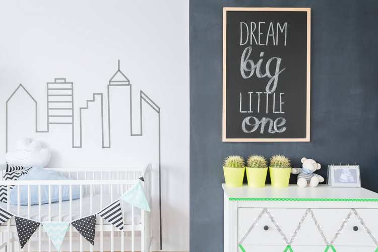 a baby room with a crib and a chalkboard