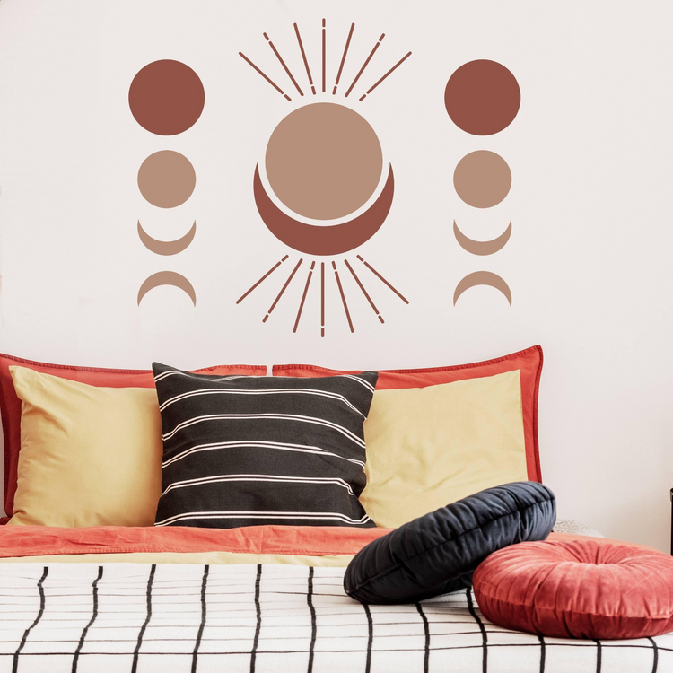 a bed with pillows and a wall sticker