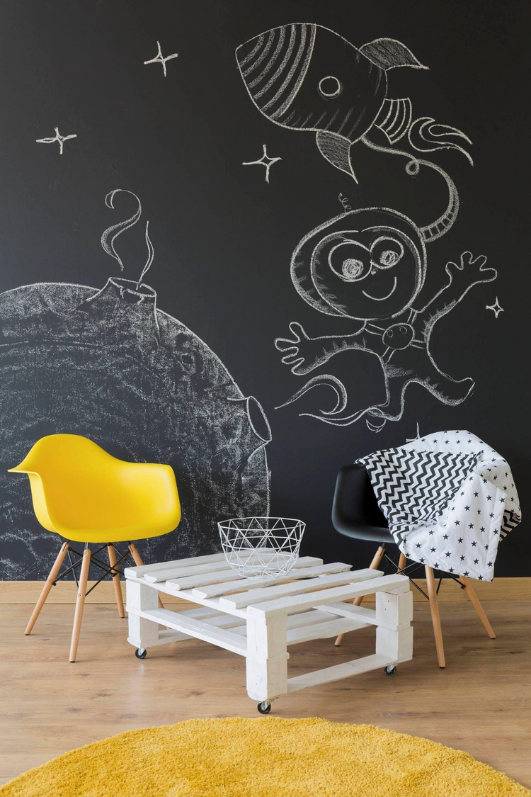 a room with a black wall and yellow chair