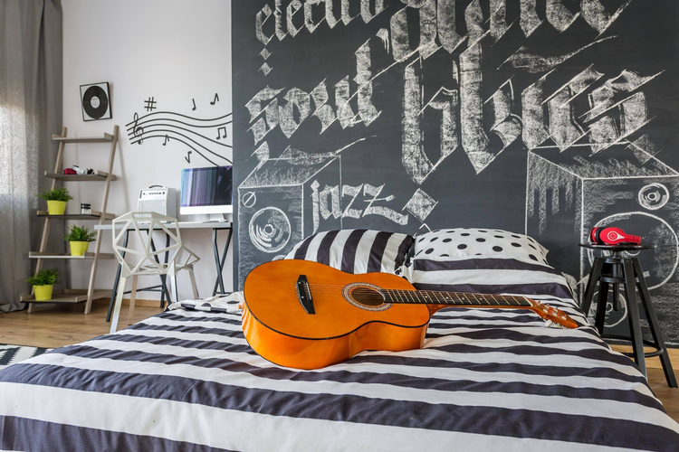 a guitar on a bed