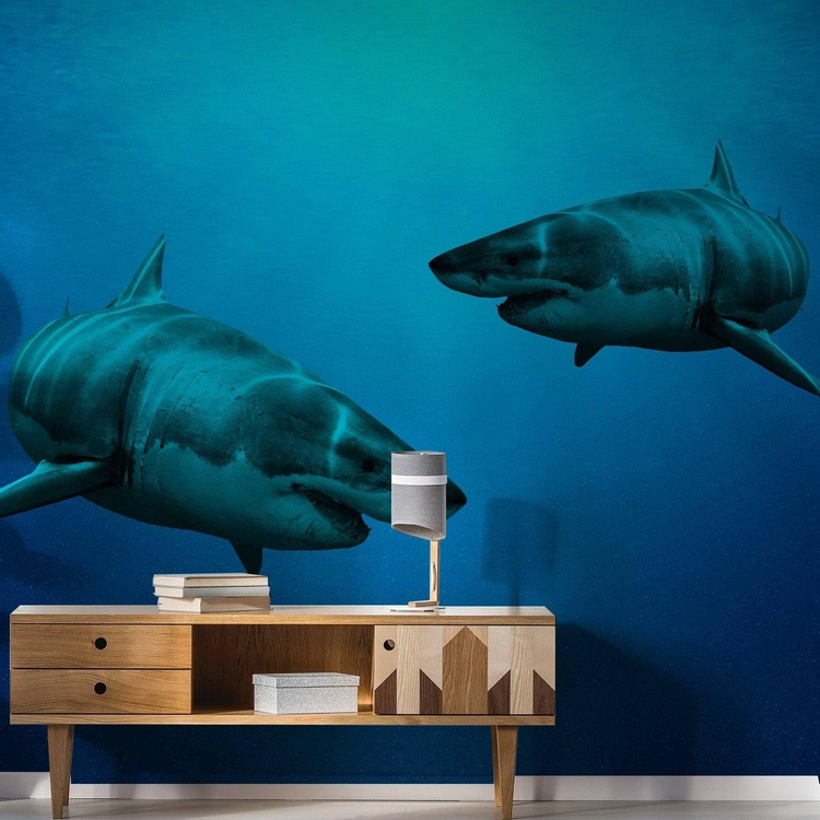 a wall mural of sharks on a blue background
