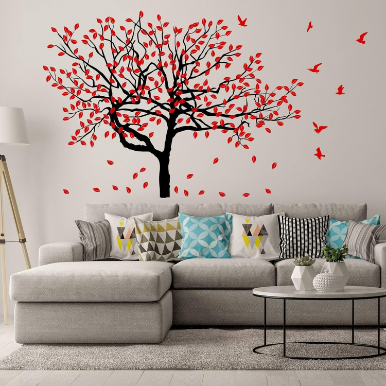 a couch with a tree and birds on the wall