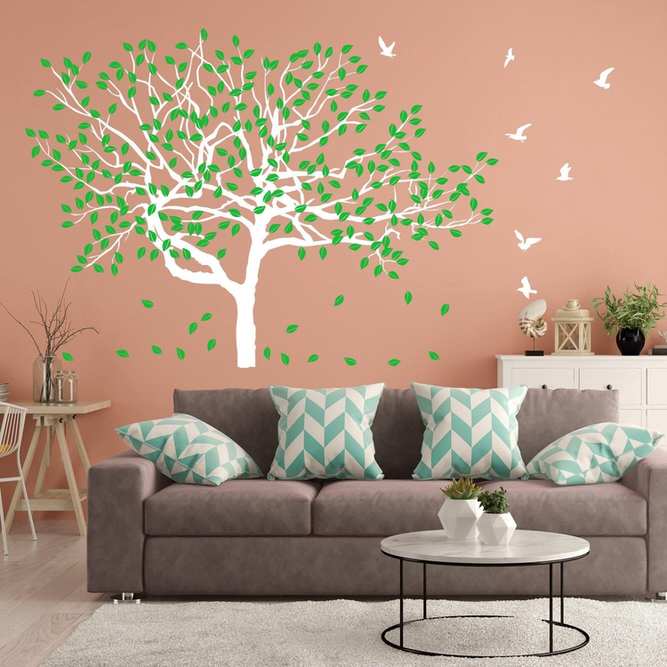 a living room with a couch and a wall decal