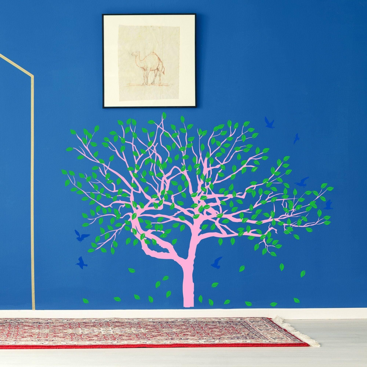 a wall with a tree and a picture on it