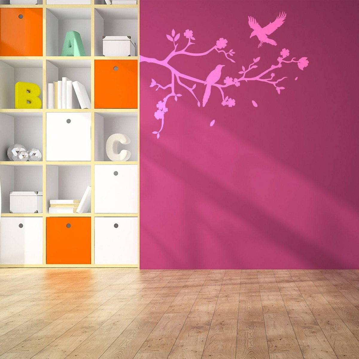 a pink wall with birds on a branch and white shelves