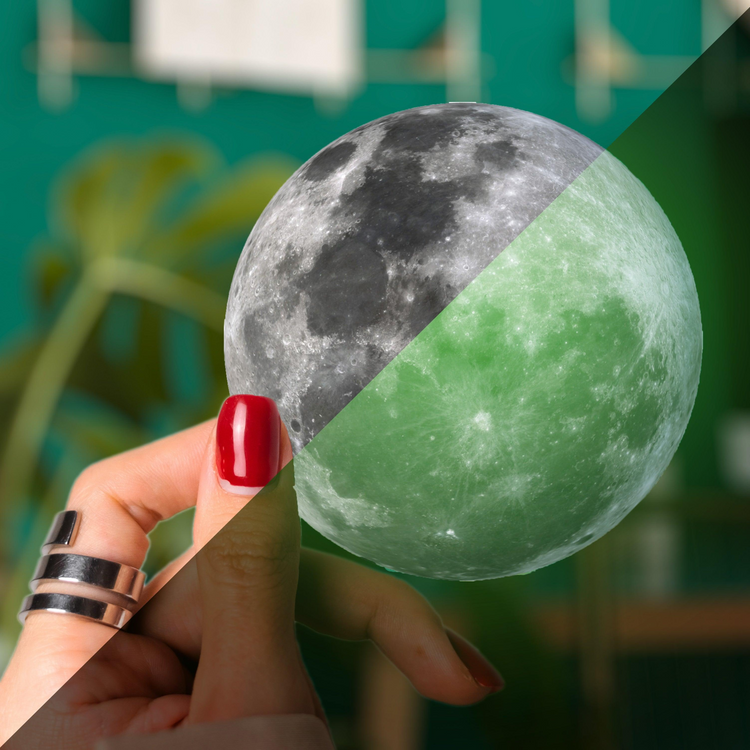 a hand holding a moon