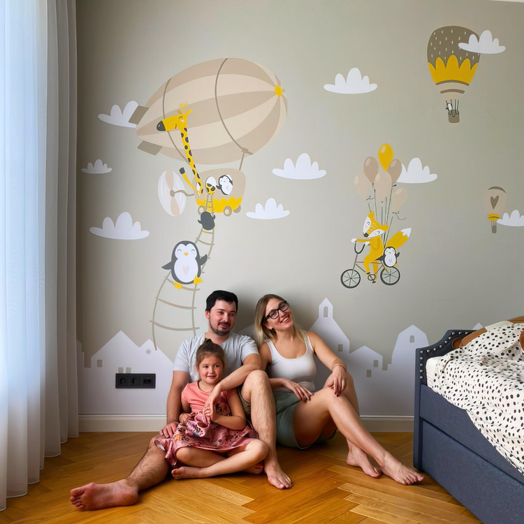 a family sitting on the floor in a room with a bed and a window