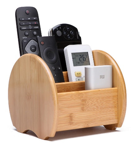 a wooden holder with remote controls and a remote control