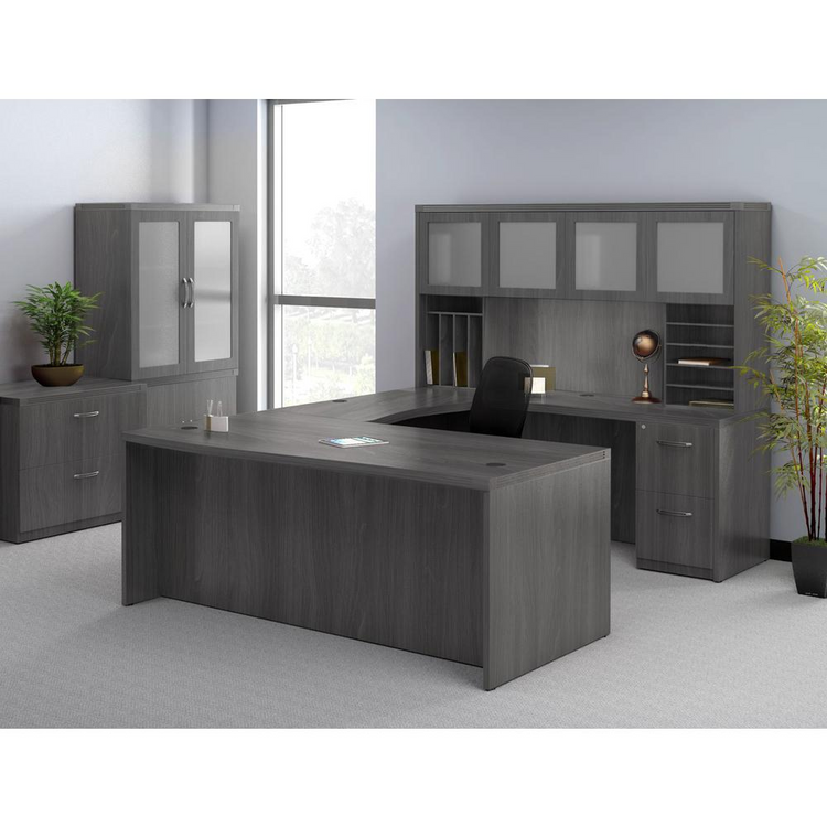 a large office desk with a chair and a plant