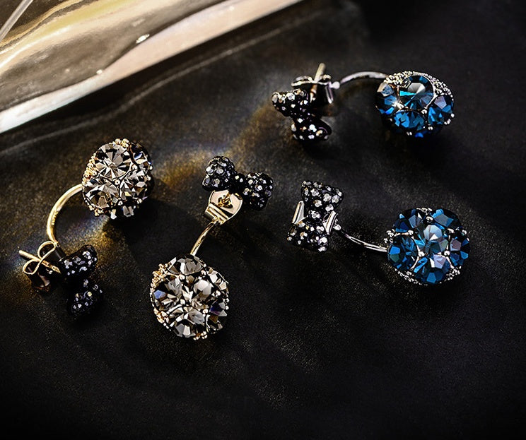 a group of earrings with blue and black stones