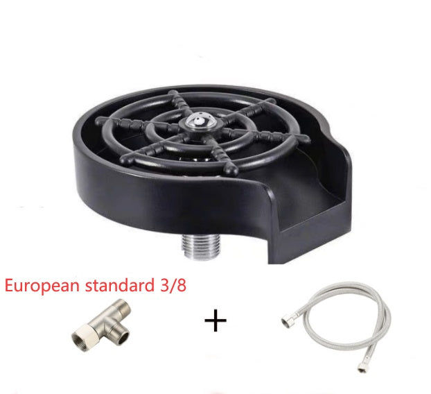 a black round object with a metal wheel and a couple of hoses