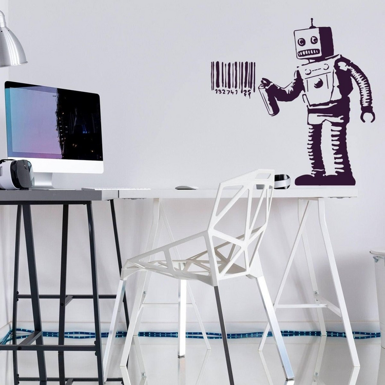a desk with a computer and a robot on it