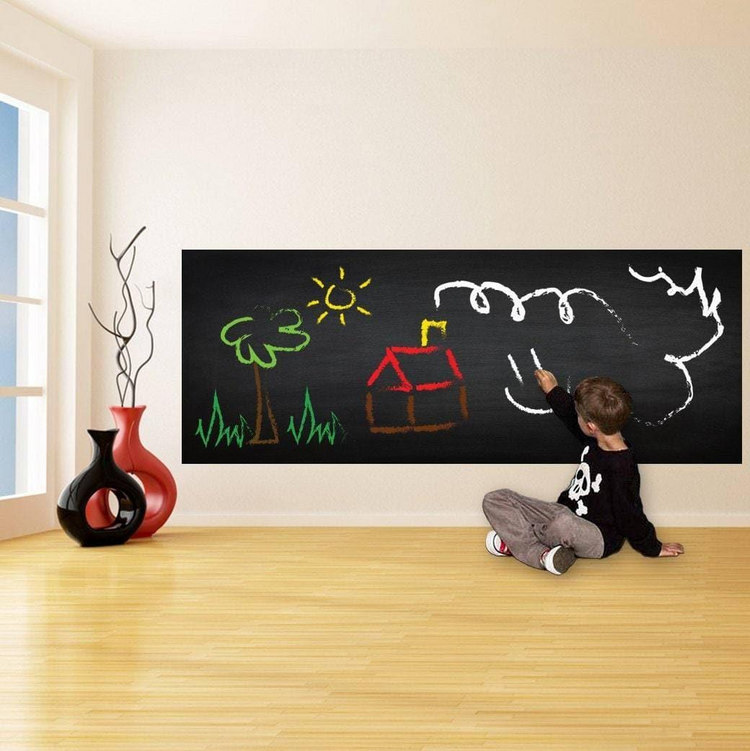 a child drawing on a chalkboard