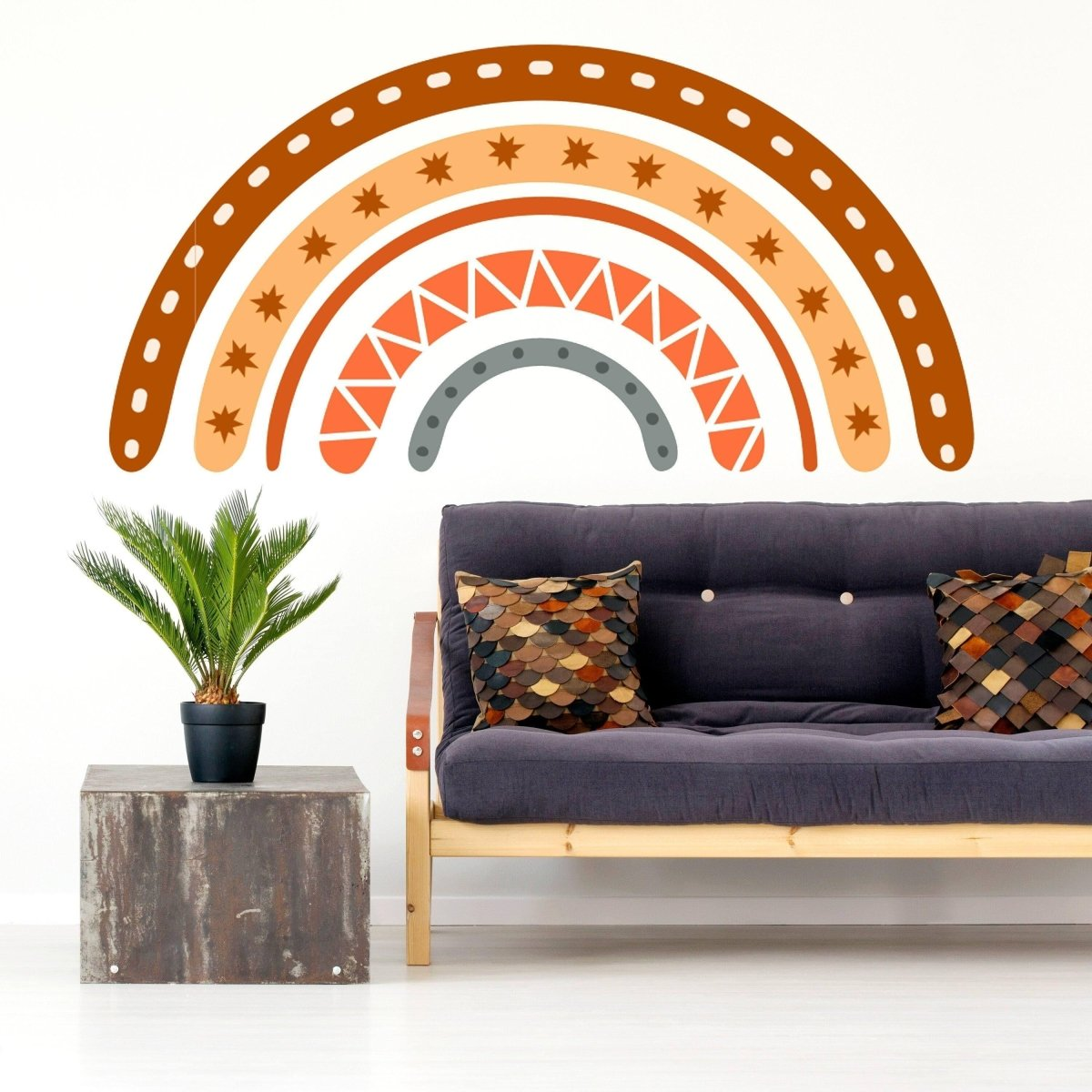 a couch with pillows and a plant in front of a wall