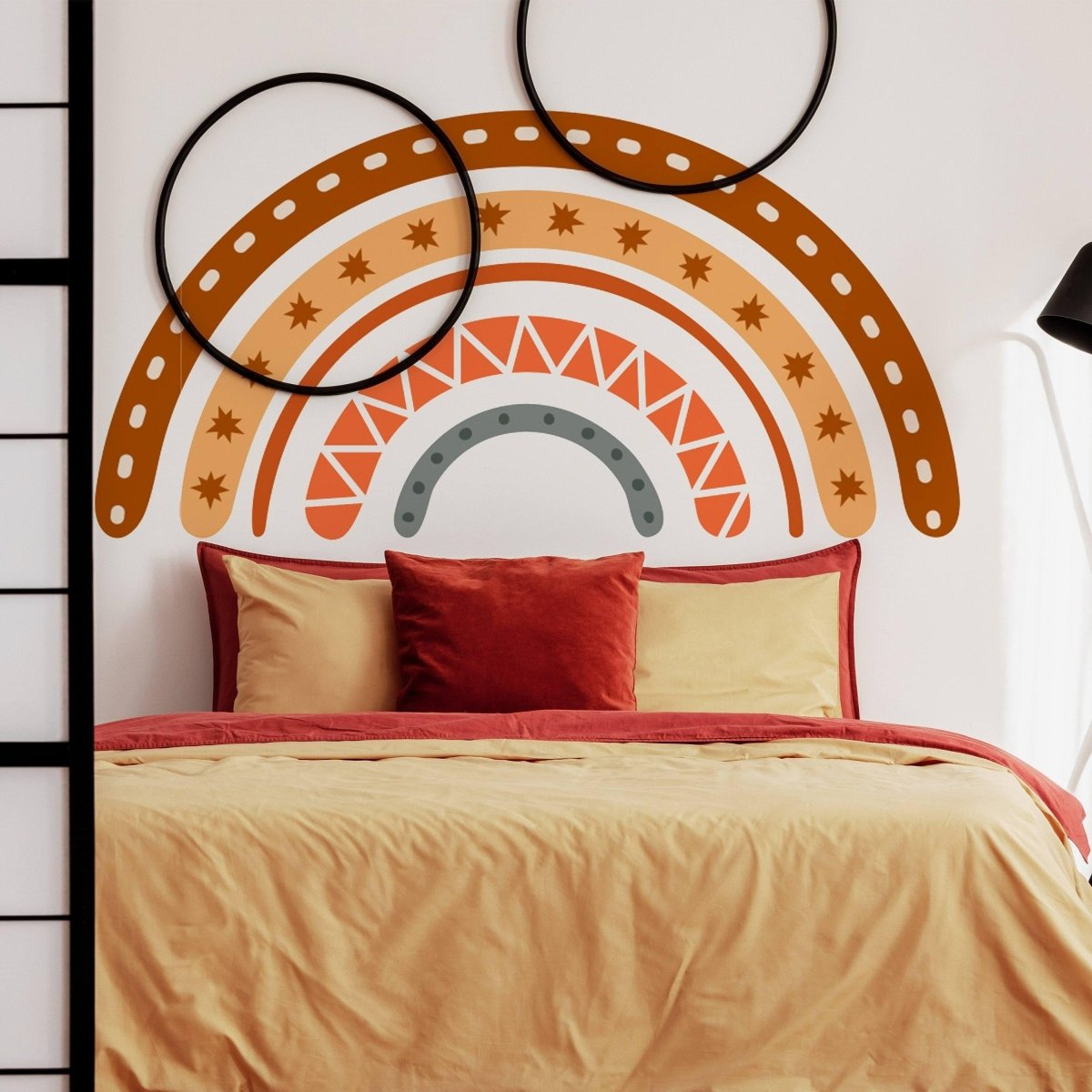 a bed with a rainbow wall art