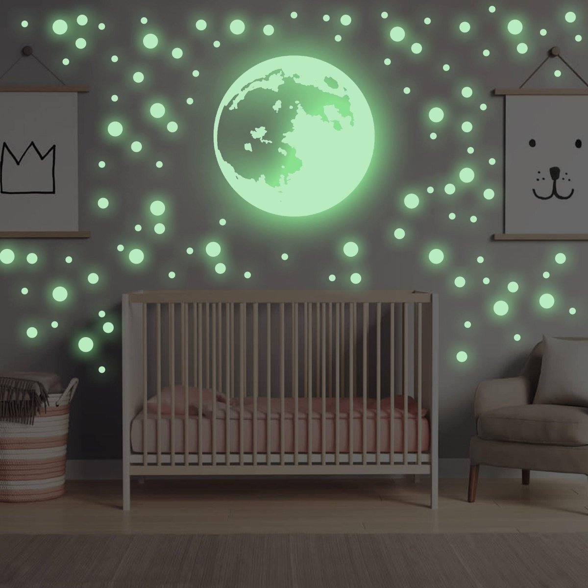 a crib with a green moon and a chair