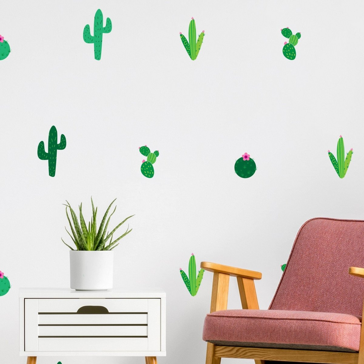 a chair and a table with cactus decals on a wall