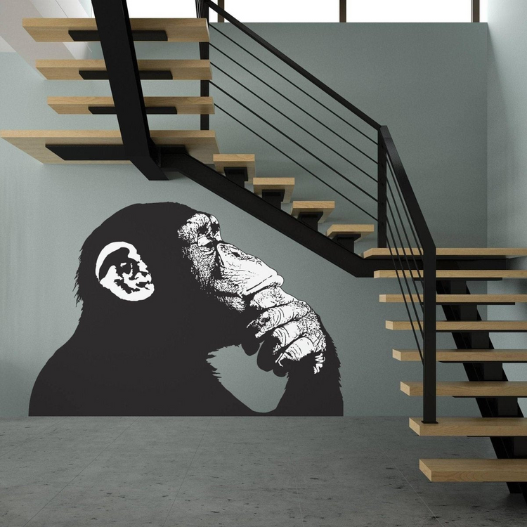a monkey painted on a wall next to a staircase